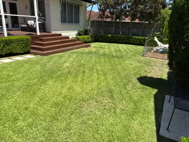 Freshly mowed back lawn beside a timber deck