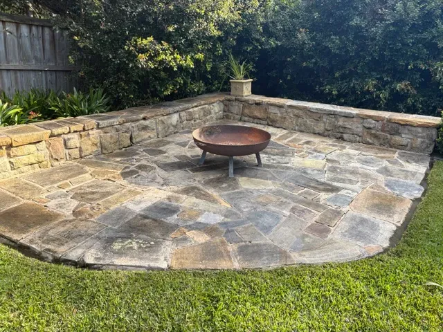 Sandstone patio with a fire pit cleared and tidied after a garden clean-up