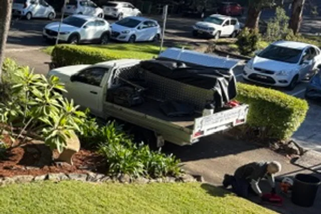 Mark loading green waste onto the ute after a garden job