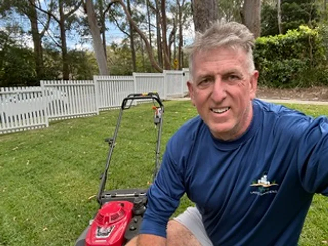 Mark from Shutt's Lawns & Gardens with his mower on a freshly mowed lawn in Turramurra